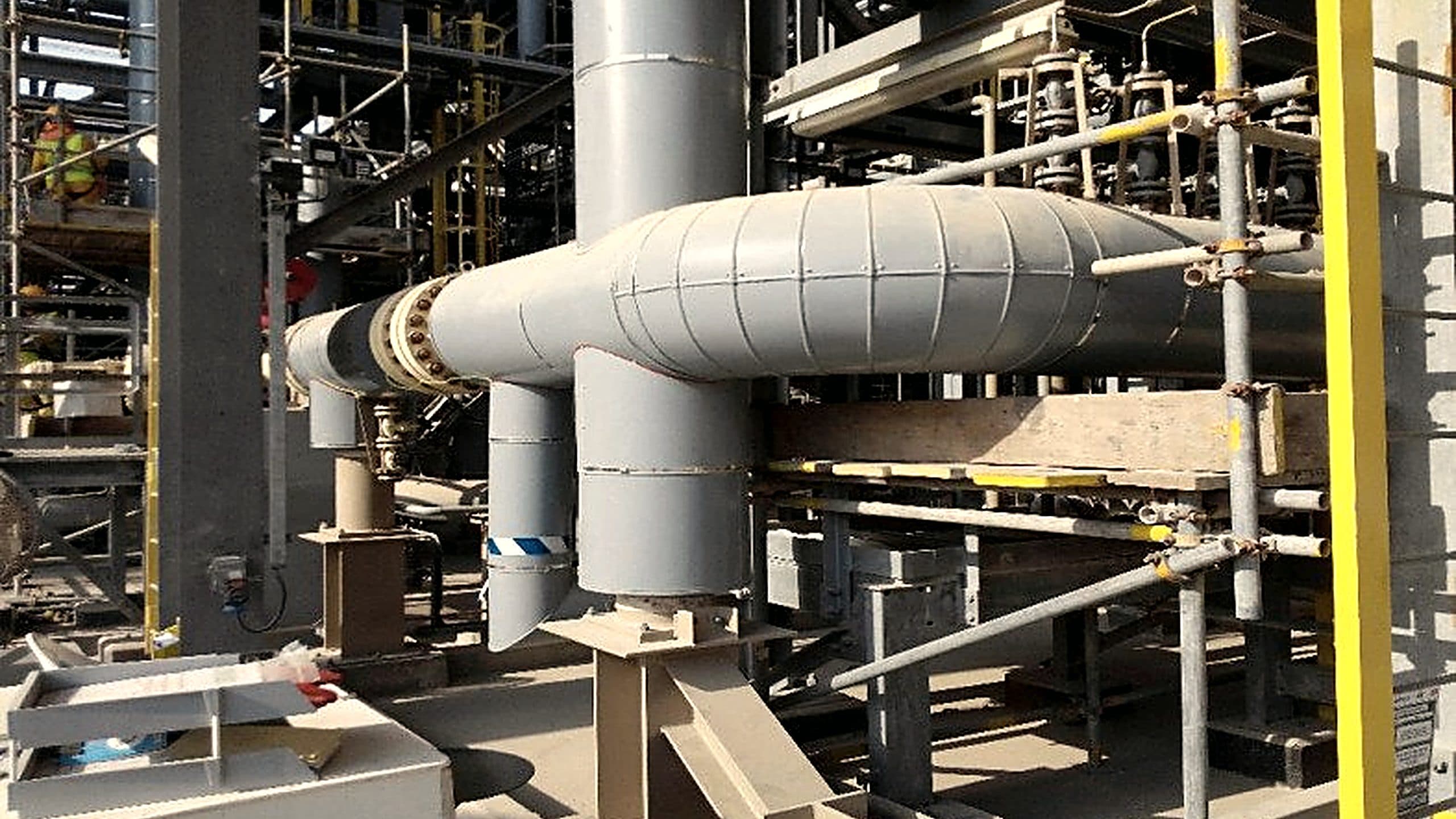 Insulated and clad process piping running through an operating plant