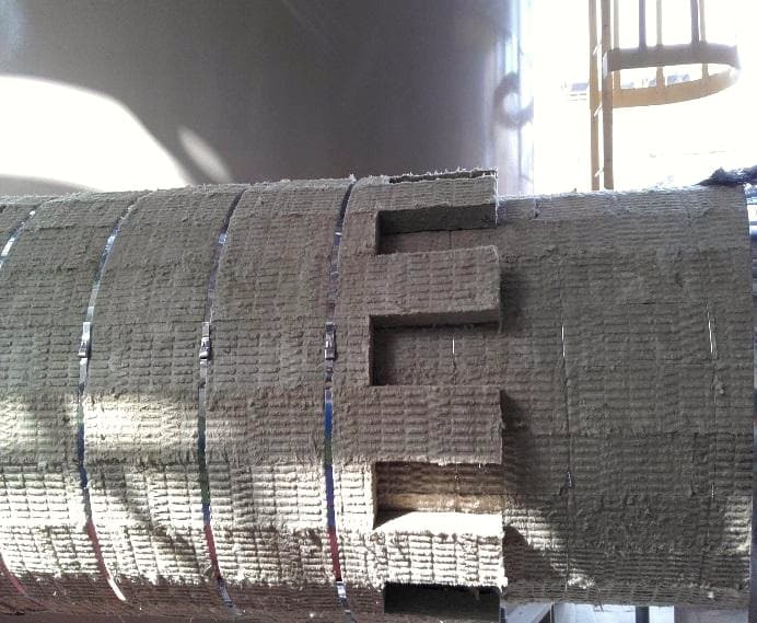 Metal cladding detail over insulation showing a stepped overlap joint