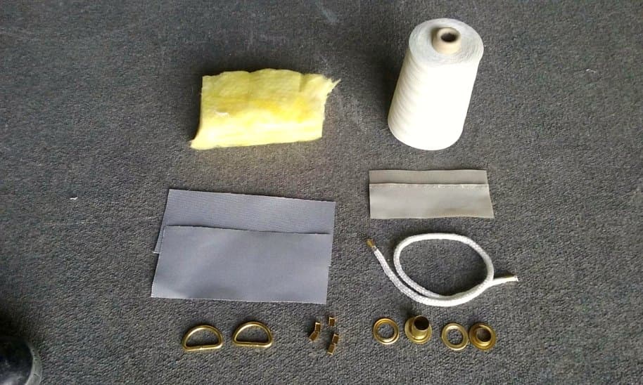 Jacket ancillaries laid out: coated glass cloth, sewing thread and brass fittings