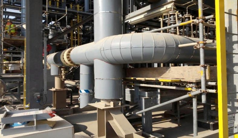 Insulated and clad process piping running through a plant structure