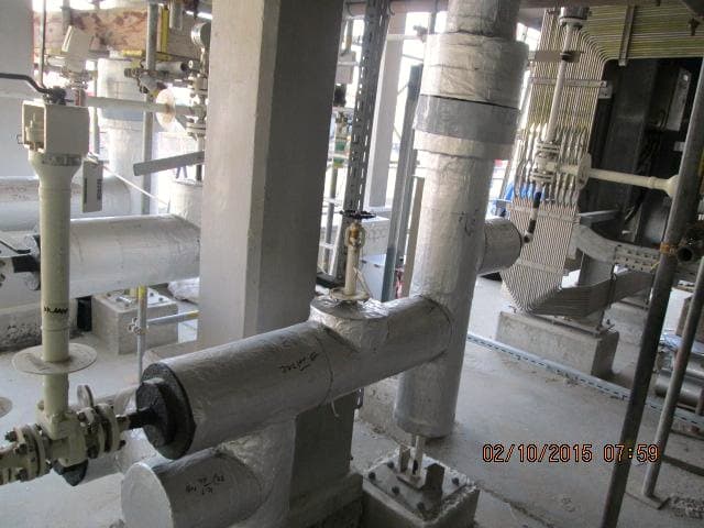 Process column and associated pipework within an operating facility